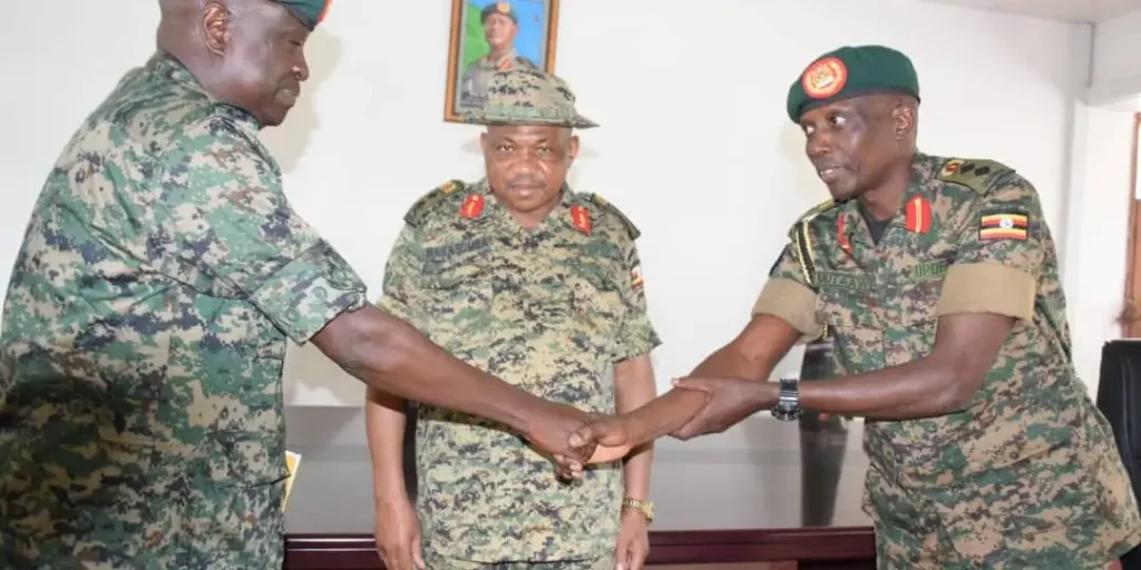 Col. Mutaawe handing over office to Col. Bagonza as Maj. Gen Jack Agoa Bakasumba looks on