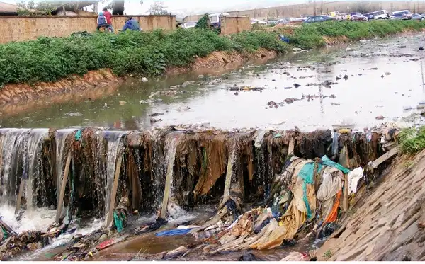 A drainage system in Kampala clogged with polythene