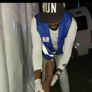 A medical personnel giving first aid to one of the injured revelers 